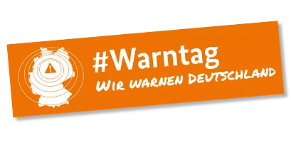 Aufschrift "Warntag wir warnen Deutschland" in weißer Schrift auf orangenen Grund. Ebenso ein Umriss von Deutschland&nbsp;&copy;&nbsp;BBK