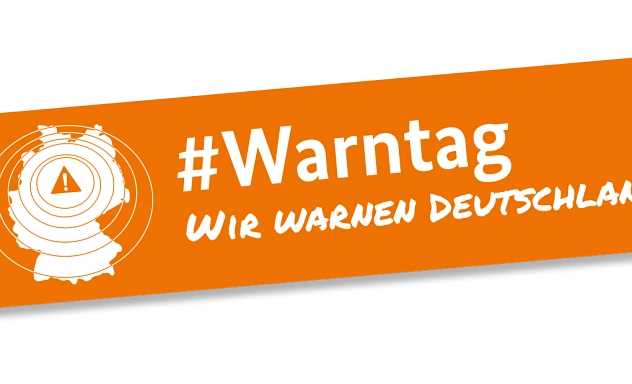 Aufschrift "Warntag wir warnen Deutschland" in weißer Schrift auf orangenen Grund. Ebenso ein Umriss von Deutschland